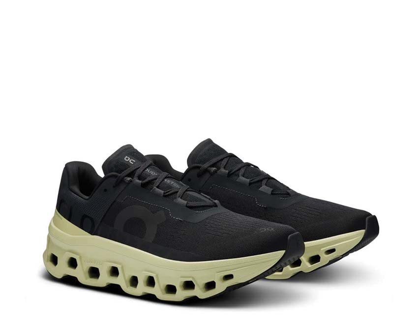 On Cloudmonster Black/Acacia vista lateral — perfil amortiguación máximo hombre
